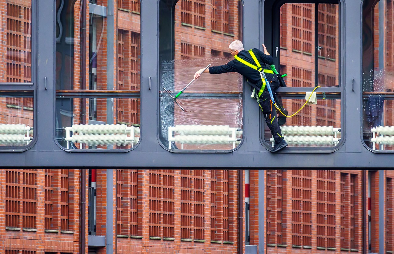 Close-up of glass being cleaned with a squeegee