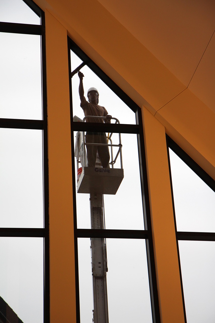 A professional window cleaner at work on a glass pane